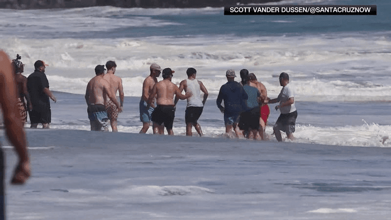 A boy was rescued after powerful waves swept him into the ocean at Seabright State Beach near the Santa Cruz Beach Boardwalk as dangerous surf battered California's coastline. (SCOTT VANDER DUSSEN/@SANTACRUZNOW via CNN Newsource)