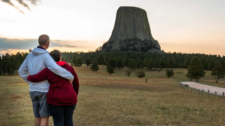 A couple viewing Devils Tower National Monument in Wyoming