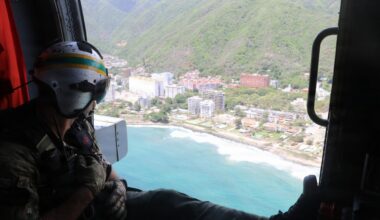 A U.S. Naval Aircrewman (Helicopter) scans the horizon from an MH-60R Seahawk, assigned to Helicopter Maritime Strike Squadron (HSM) 48 during flight operations off the coast of Venezuela, June 29, 2026.