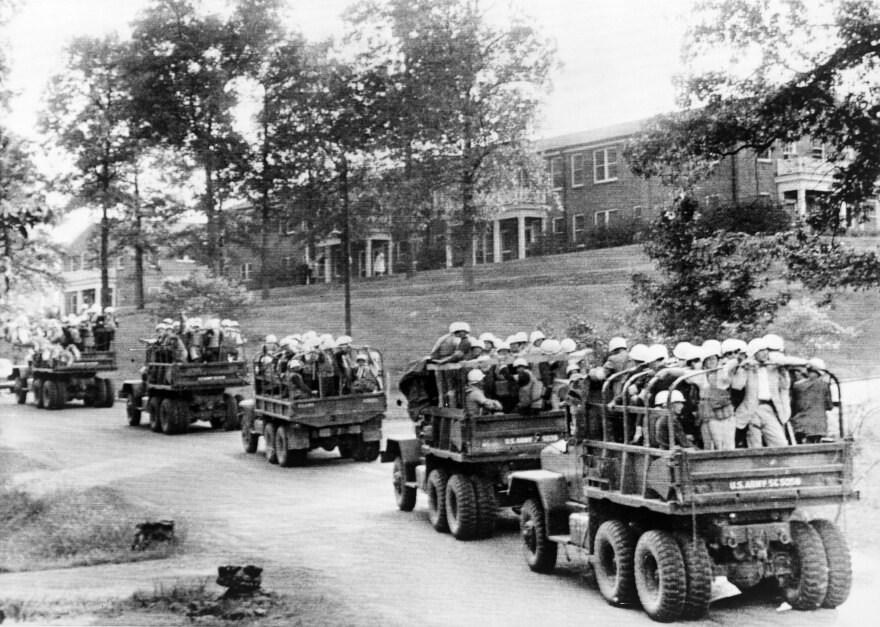 A convoy of U.S. Army vehicles descend upon the University of Mississippi in October 1962 to help integrate the school. The school was under pressure from the federal government and accreditor SACSCOC to accept James Meredith, a Black student.