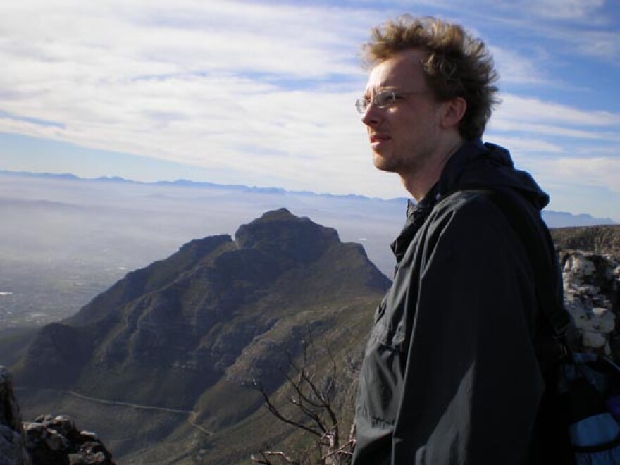 Isaac Kamola looks out on a mountain view in Cape Town, South Africa