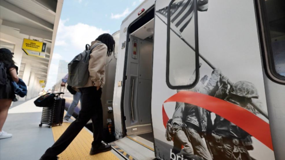 Brightline passengers in West Palm Beach board a "Freedom Express" train, featuring a wrap of iconic images from U.S. history to commemorate the 250th anniversary of the U.S. The railroad is again offering multi-ride passes to riders between West Palm Beach and Fort Lauderdale. (Amy Beth Bennett/South Florida Sun Sentinel)