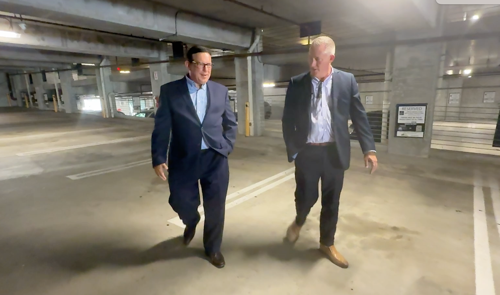 Jamie Adair shows Adam Walser where he was parked when his vehicle was towed by Comm Tow