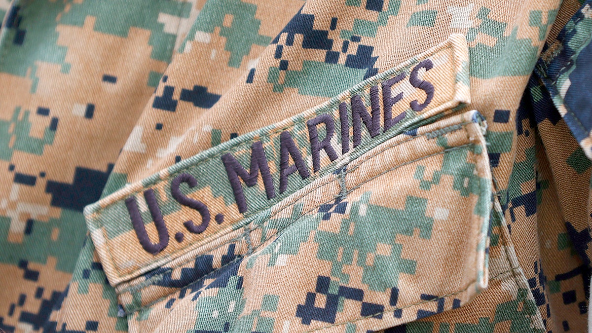 U.S. Marines patch on uniform.