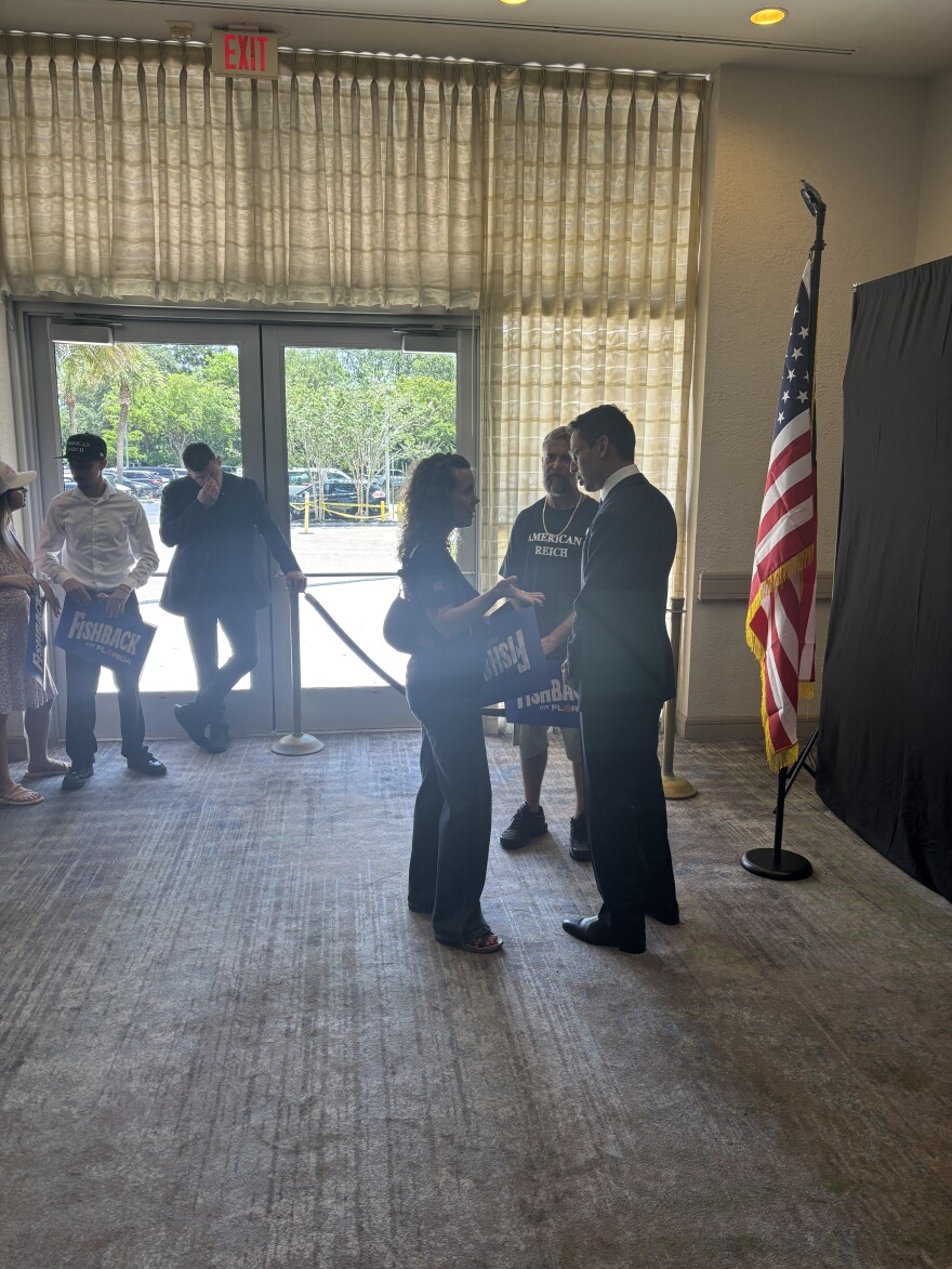 Fishback greets supporters before delivering a speech at a Fort Lauderdale hotel ballroom on June 27, 2026. Several are wearing shirts and hats emblazoned with the words, "American Reich," — an apparent reference to the Nazi's third Reich. It symbolizes one half of the duality of supporters for Fishback's surging campaign for governor.
