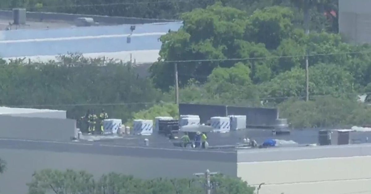 Crews work to extinguish warehouse fire in Doral, officials say