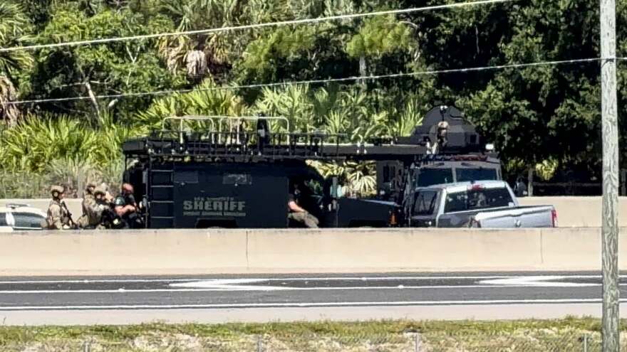 FHP and Lee Sheriff personnel at the scene of a crash and shooting along southbound I-75 at Alico Road Wednesday afternoon. Southbound lanes of the freeway at Alico Road have been shut down.