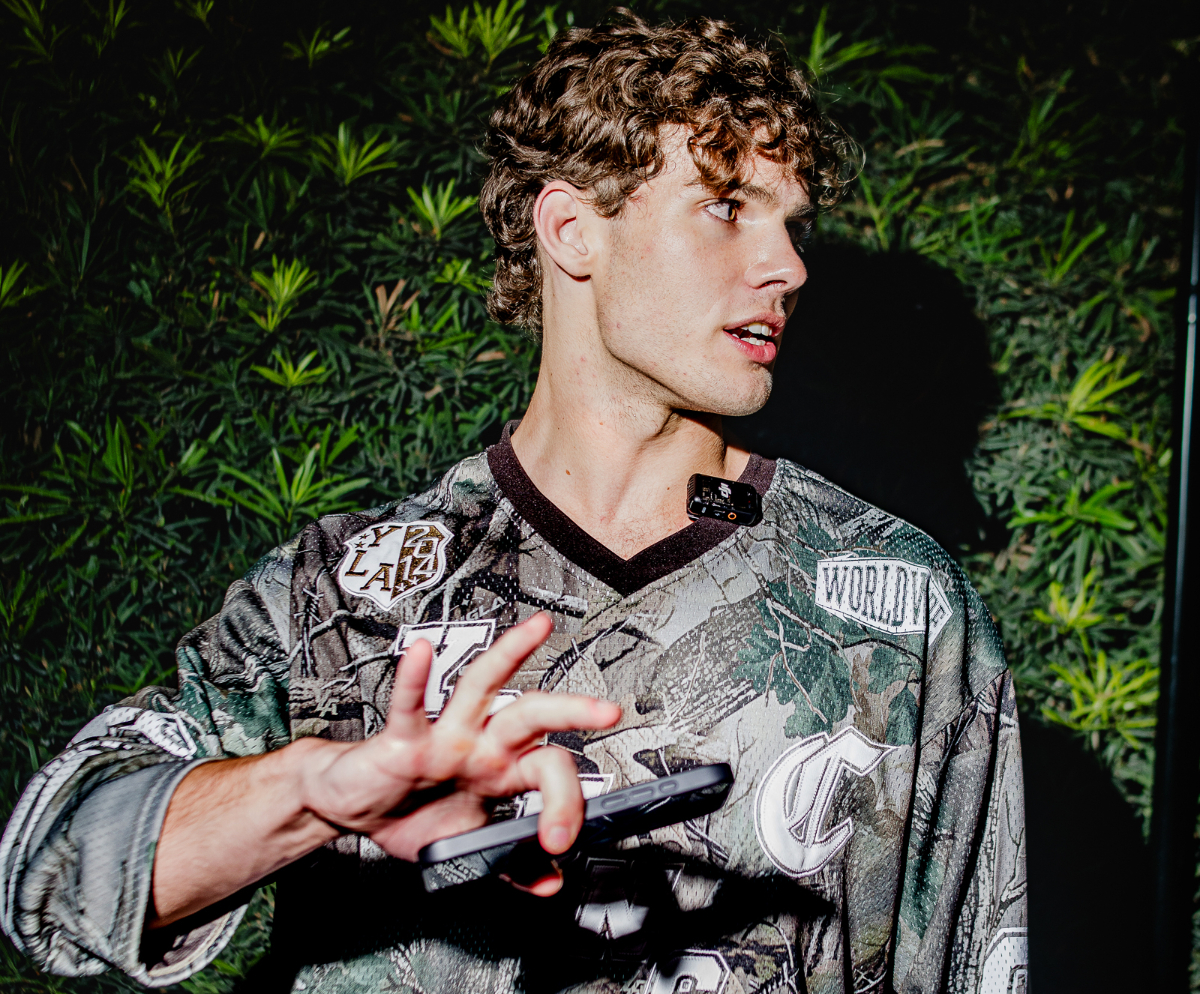 A young man puts his hand in front of a camera
