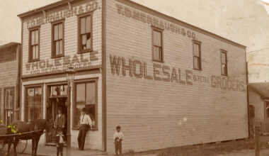 Photo shows wood building from downtown Orlando in the 1890s with a horse, 2 men and 2 boys