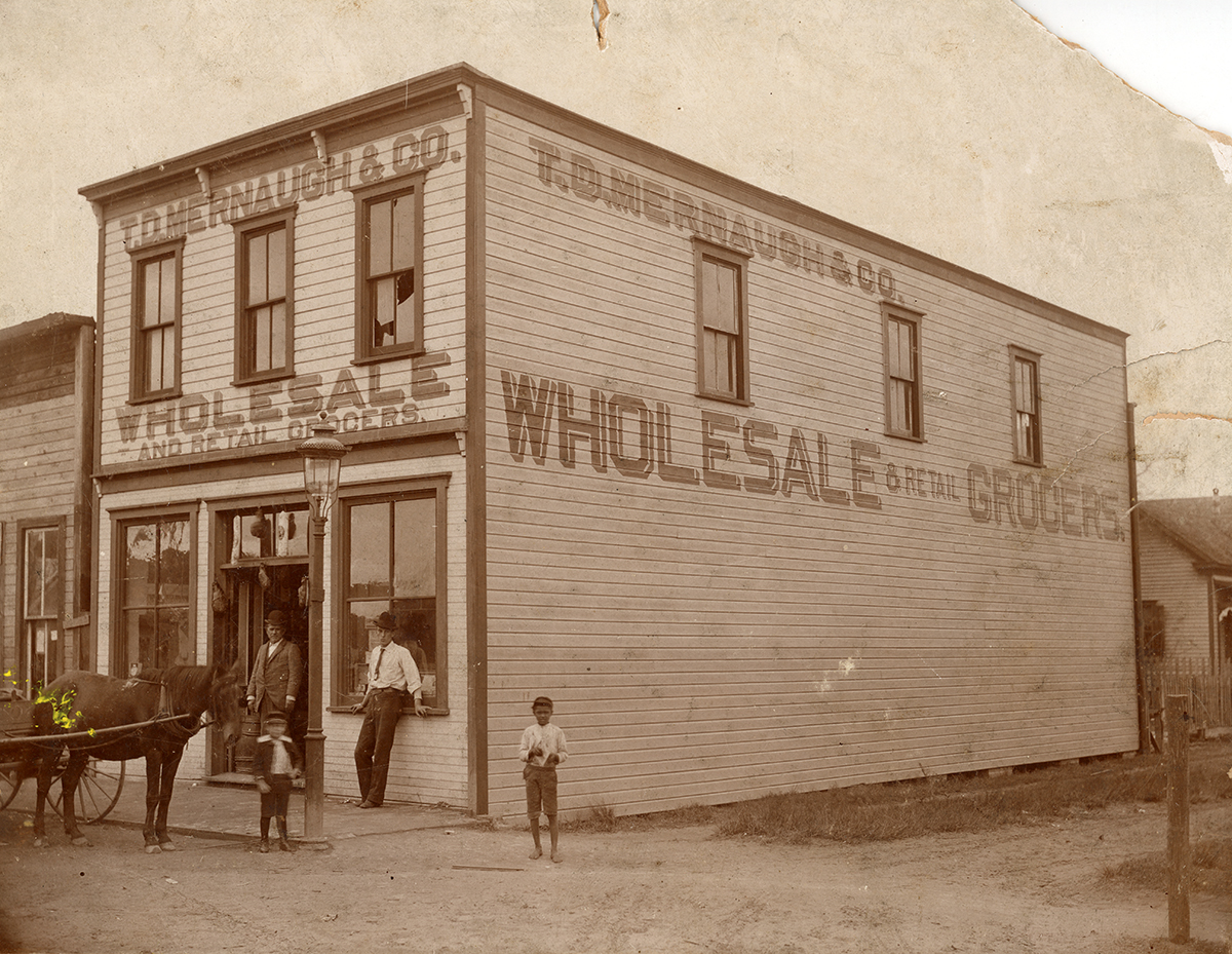 Photo shows wood building from downtown Orlando in the 1890s with a horse, 2 men and 2 boys
