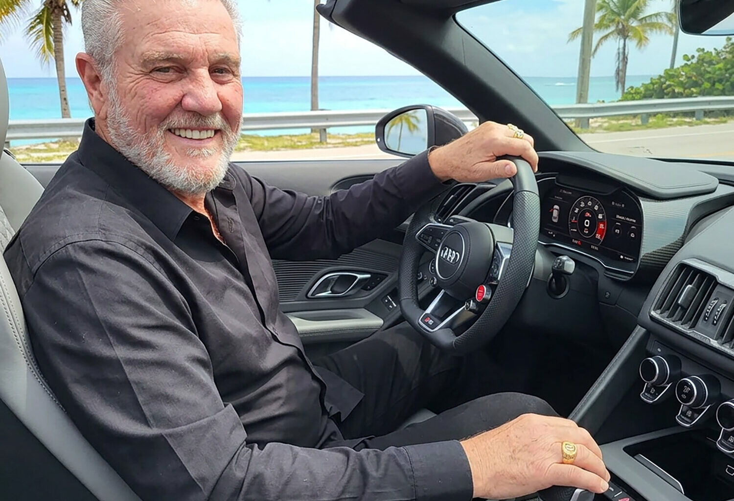 Glen Rimondi sits in an Audi R8 Spyder