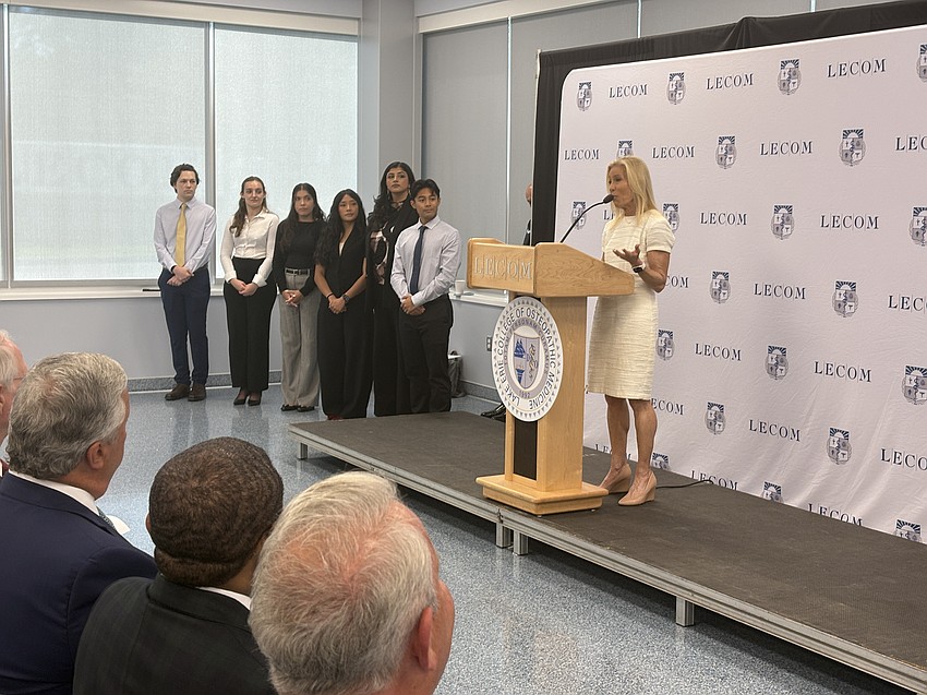 Mayor Donna Deegan, flanked by members of LECOM’s inaugural class, speaks at LECOM at Jacksonville University’s ribbon-cutting ceremony.