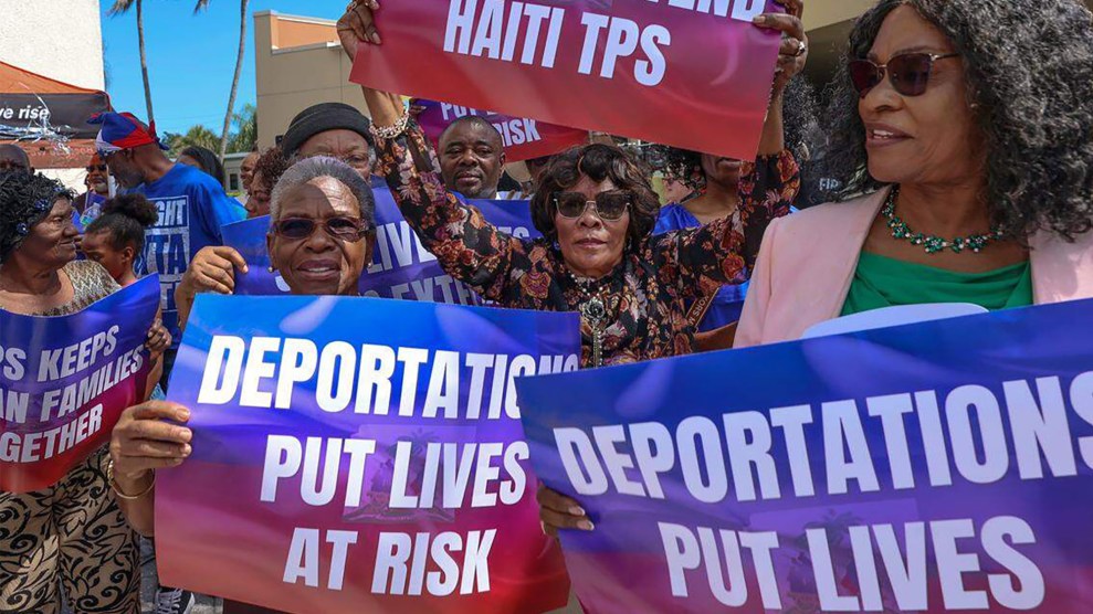 A group of Haitian women hold signs in protesting the deportation of immigrants with Temporary Protected Status.