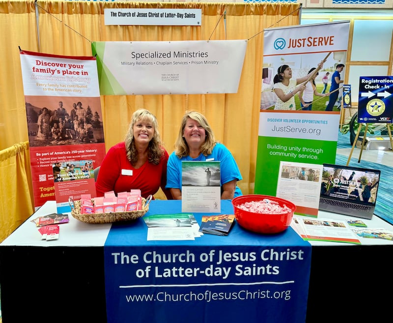Jennifer Samuels and Kim Fredrick sit at the Church's booth in the health and wellness expo during the 2026 National Veterans Golden Age Games in Tampa, Florida, on June 27.