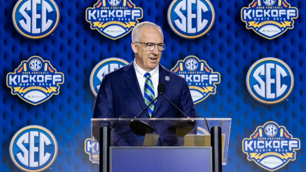 SEC Commissioner Greg Sankey speaks at the podium during the 2026 SEC Football Media Days in downtown Tampa.