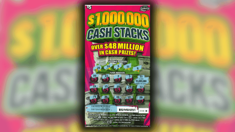 Jean Olsen and guest pose with an oversized check after claiming a $1 million top prize from the $1,000,000 CASH STACKS Scratch-Off game at Florida Lottery Headquarters in Tallahassee. (Florida Lottery)