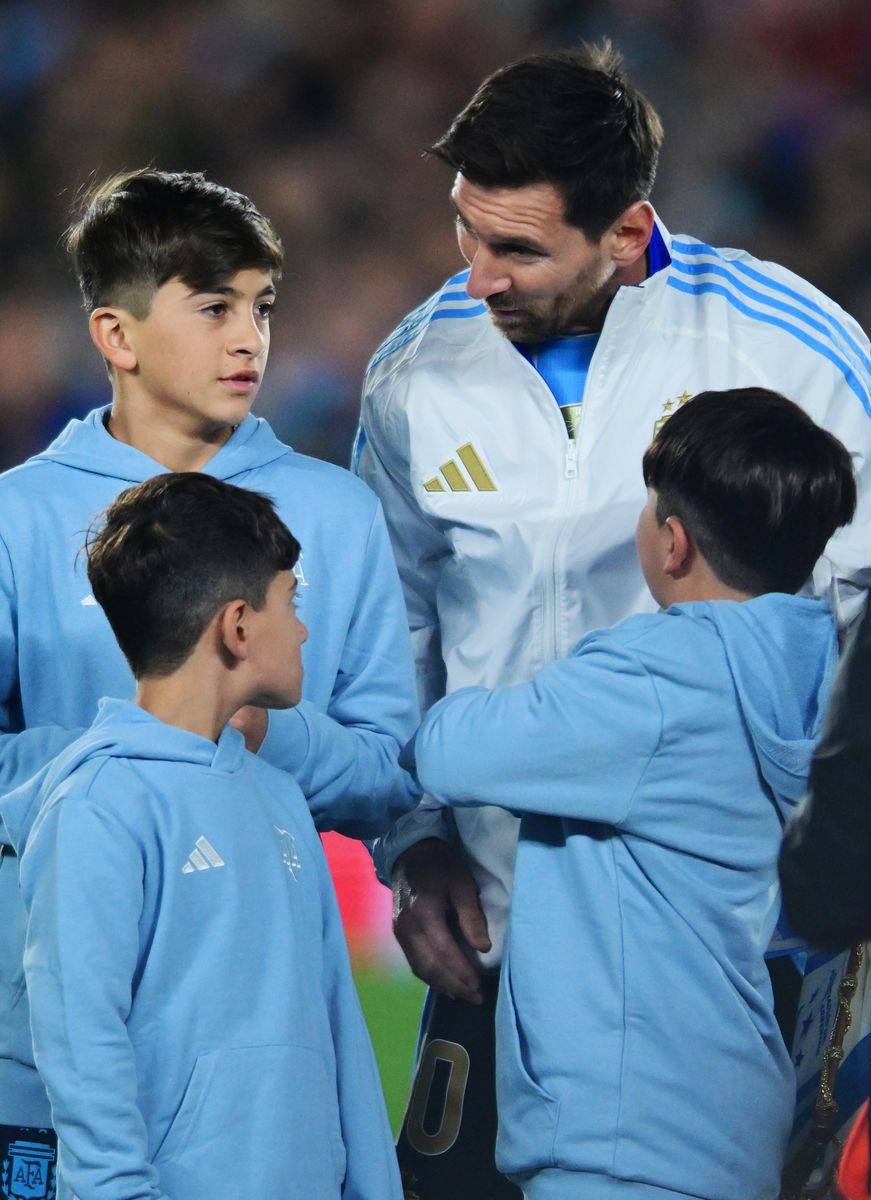 Lionel Messi of Argentina talks to his children, Thiago, Mateo and Ciro 