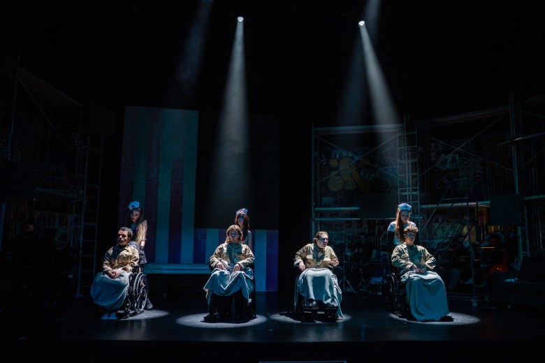 Musical improv performers live on stage creating Christmas songs from audience input.