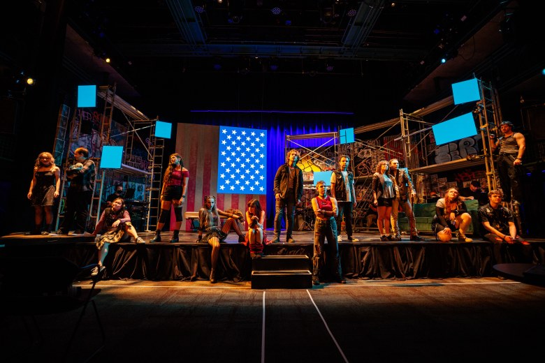 Musical improv performers live on stage creating Christmas songs from audience input.