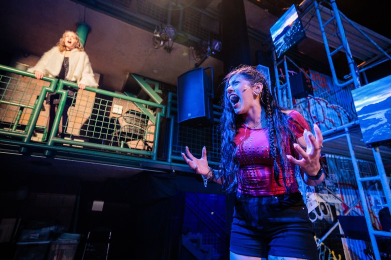 Musical improv performers live on stage creating Christmas songs from audience input.