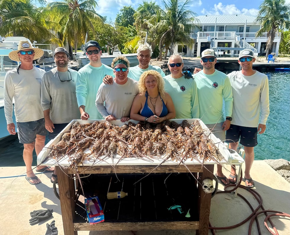 Friends from Manatee and Sarasota counties pose with their Florida spiny lobster catch during...
