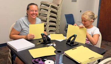 Working side by side, volunteers create oneof a-kind journals that promote both sustainability and learning. (L-R): Elizabeth McCormack and Analucia Cierebiej.