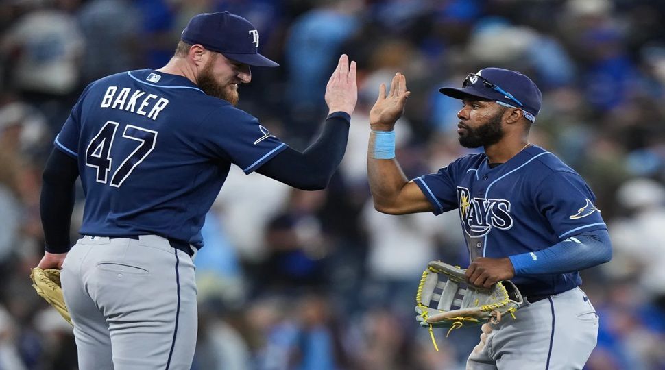 Tampa Bay Rays outfielder Cedric Mullins, right, celebrates with Bryan Baker (47) after defeating the Toronto Blue Jays in a baseball game in Toronto on Wednesday, July 22, 2026. (Nathan Denette/The Canadian Press via AP)