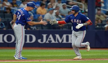 Texas Rangers' Austin Wynns celebrates his solo home run off Tampa Bay Rays pitcher Steven Matz with third base coach Corey Ragsdale (64) during the seventh inning of a baseball game Tuesday, July 28, 2026, in St. Petersburg, Fla. (AP Photo/Chris O'Meara)