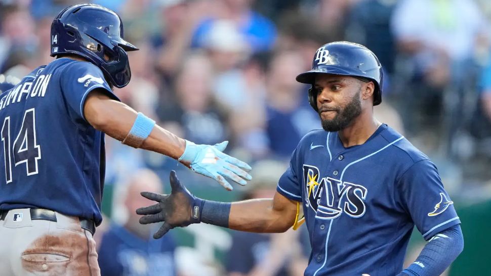 Tampa Bay Rays' Cedric Mullins, right, celebrates with Chandler Simpson (14) after hitting a two-run home run during the fifth inning of a baseball game against the Kansas City Royals, Thursday, July 2, 2026, in Kansas City, Mo. (AP Photo/Charlie Riedel)