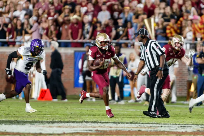 Nov 18, 2023; Tallahassee, Florida, USA; Florida State Seminoles running back Samuel Singleton Jr. (28) runs with the ball past North Alabama Lions defensive back Gregory Reddick (9) during the fourth quarter at Doak S. Campbell Stadium. Mandatory Credit:
Morgan Tencza-USA TODAY Sports