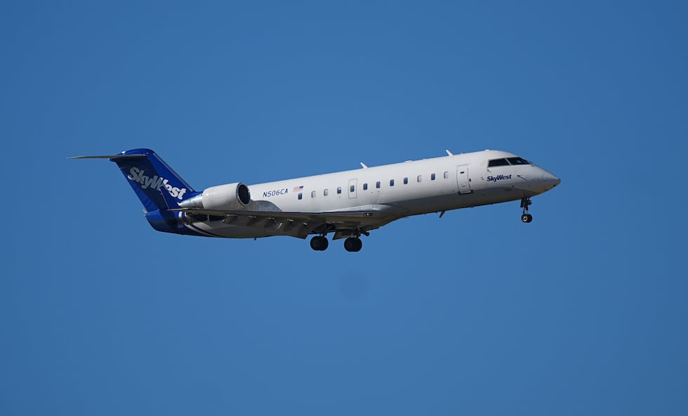 FILE - A SkyWest commuter jet lands at Denver International Airport on Thursday, Oct. 2, 2025,...