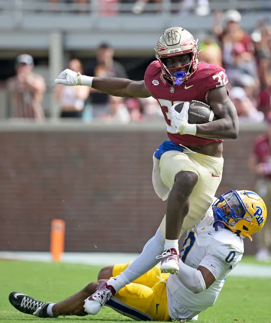 Oct 11, 2025; Tallahassee, Florida, USA; Florida State Seminoles running back Ousmane Kromah (32) is tackled by Pittsburgh Panthers linebacker Braylan Lovelace (0) during the second half at Doak S. Campbell Stadium. Mandatory Credit: Melina Myers-Imagn Images