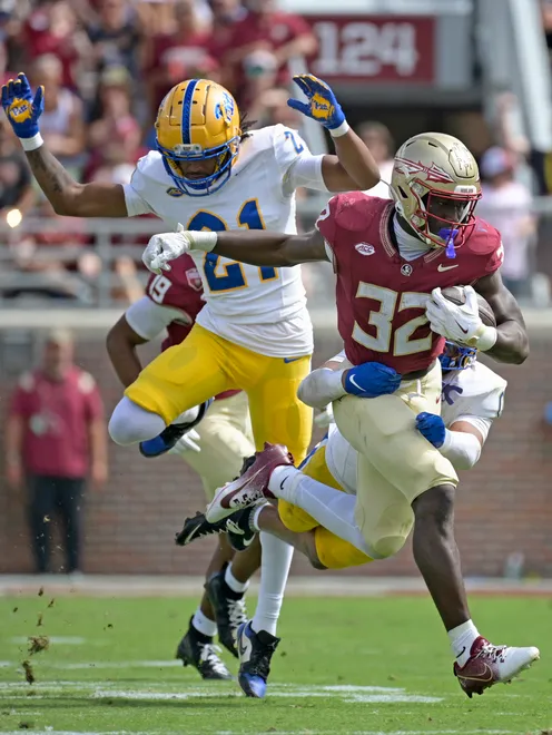 Florida State Seminoles running back Ousmane Kromah (32) runs the ball past Pittsburgh Panthers defensive back Shadarian Harrison (21) during the second half Oct. 11, 2025 at Doak S. Campbell Stadium in Tallahassee, Florida. Mandatory Credit: Melina Myers-Imagn Images