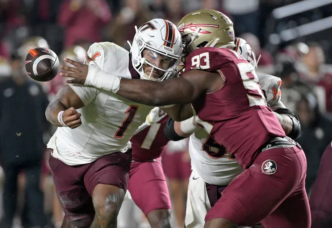 Nov 15, 2025; Tallahassee, Florida, USA; Virginia Tech Hokies quarterback Kyron Drones (1) has the ball knocked away by Florida State Seminoles defensive lineman Mandrell Desir (93) during the second half at Doak S. Campbell Stadium. Mandatory Credit: Melina Myers-Imagn Images