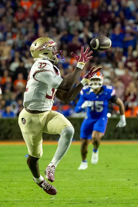 Nov 29, 2025; Gainesville, Florida, USA; Florida State Seminoles running back Ousmane Kromah (32) drops the ball during the second quarter against the Florida Gators at Ben Hill Griffin Stadium. Mandatory Credit: Bob Kupbens-Imagn Images