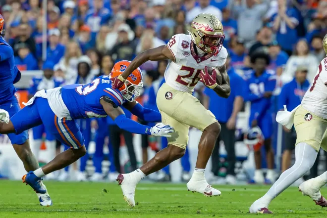 Florida State running back Samuel Singleton Jr. (28) breaks away from a tackle attempt by a Florida Gators defensive back during the second quarter of the Sunshine Showdown on Saturday, Nov. 29.