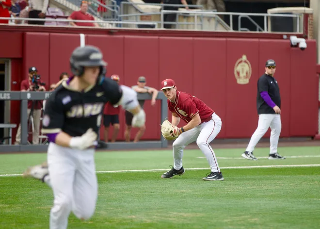 Bryson Moore throws to first base as Florida State baseball beat James Madison 16-5 on Saturday, Feb. 14 at Dick Howser Stadium