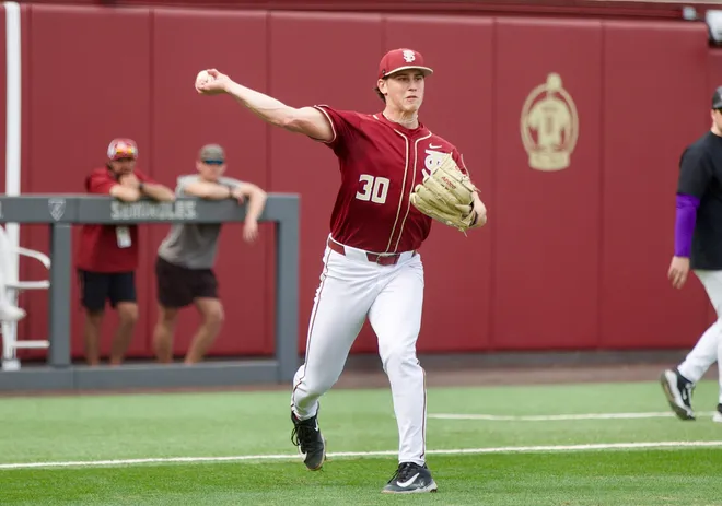 Bryson Moore throws to first base as Florida State baseball beat James Madison 16-5 on Saturday, Feb. 14 at Dick Howser Stadium