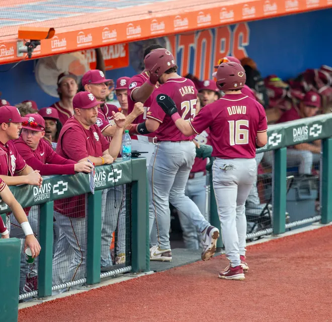 Florida State outfielder Brayden Dowd (16) and Florida State catcher Hunter Carns (25) score for Florida State against Florida, March 10, 2026, at Condron Family Ballpark in Gainesville, Florida. [Cyndi Chambers/ Gainesville Sun] 2026