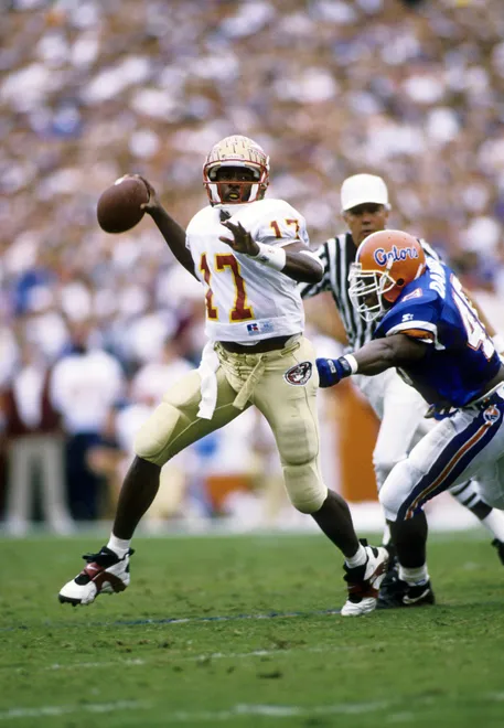 Nov 27, 1993; Gainesville, FL, USA: FILE PHOTO; Florida State Seminoles quarterback Charlie Ward (17) rolls out to throw the ball against Florida at Ben Hill Griffin Stadium. FSU defeated Florida 33-21 Mandatory Credit: USA TODAY Sports