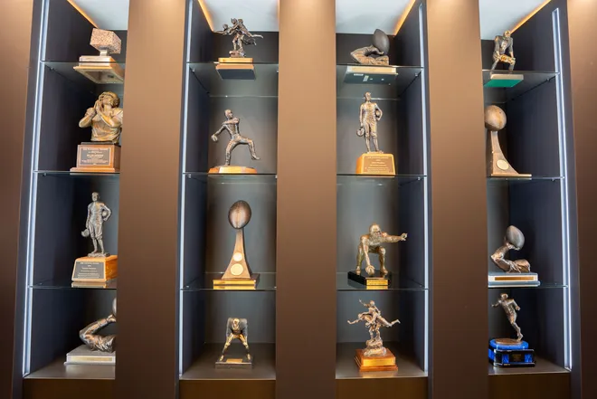 Trophies earned by former Florida State football players are displayed inside the Florida State University Dunlap Football Center.