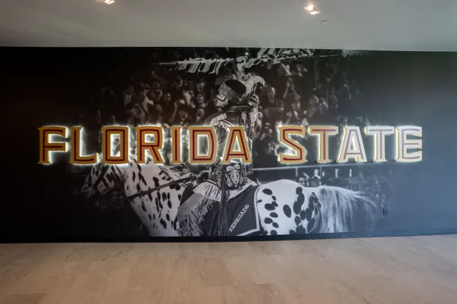 An image of Osceola and Renegade is displayed on a wall inside the Florida State University Dunlap Football Center.
