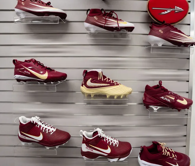 Cleat options for players are displayed on a wall in the equipment room inside the Florida State University Dunlap Football Center.