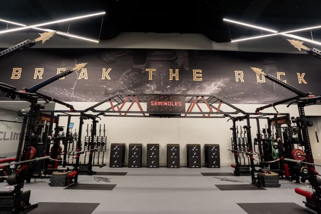 The words “break the rock” are displayed at the top of the wall in the weight room inside the Florida State University Dunlap Football Center.