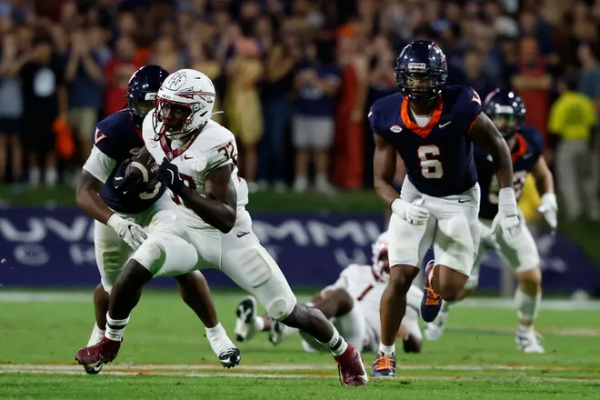 Sep 26, 2025; Charlottesville, Virginia, USA; Florida State Seminoles running back Ousmane Kromah (32) carries the ball past Virginia Cavaliers defensive end Cazeem Moore (6) at Scott Stadium. Mandatory Credit: Geoff Burke-Imagn Images