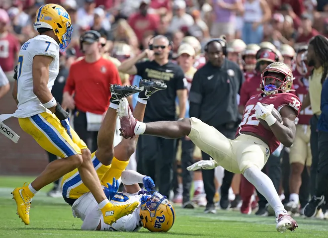 Oct 11, 2025; Tallahassee, Florida, USA; Florida State Seminoles running back Ousmane Kromah (32) is tackled by Pittsburgh Panthers linebacker Braylan Lovelace (0) during the second half at Doak S. Campbell Stadium. Mandatory Credit: Melina Myers-Imagn Images