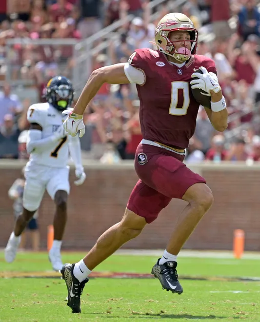 Sep 6, 2025; Tallahassee, Florida, USA; Florida State Seminoles wide receiver Duce Robinson (0) catches a touchdown during the first half against the East Texas A & M at Doak S. Campbell Stadium. Mandatory Credit: Melina Myers-Imagn Images