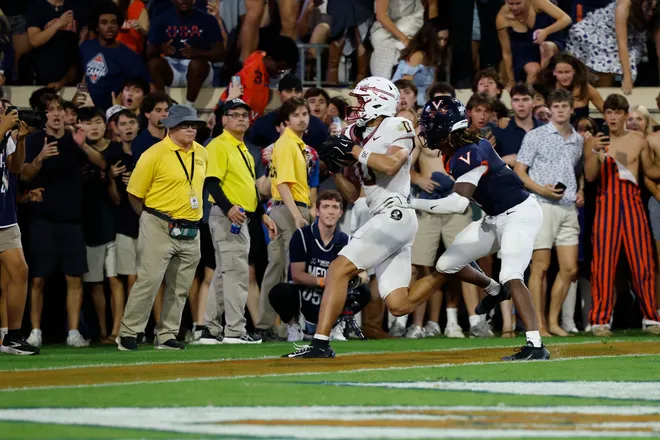 Sep 26, 2025; Charlottesville, Virginia, USA; Florida State Seminoles wide receiver Duce Robinson (0) attempts to catch a game-tying touchdown pass as Virginia Cavaliers cornerback Jam Jackson (9) chases in the second overtime at Scott Stadium. Mandatory Credit: Geoff Burke-Imagn Images