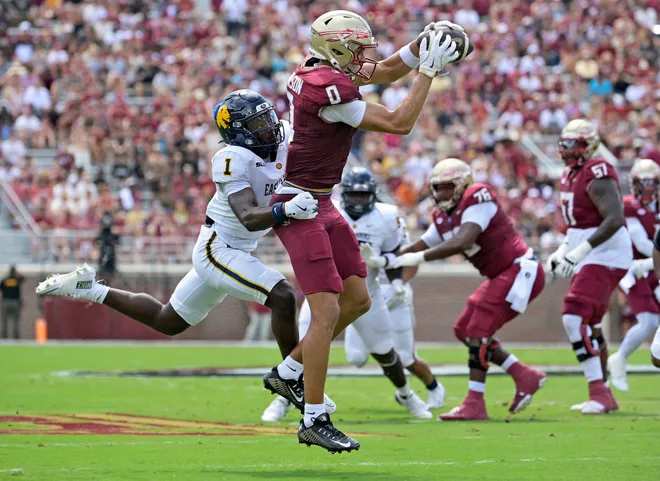 Sep 6, 2025; Tallahassee, Florida, USA; Florida State Seminoles wide receiver Duce Robinson (0) catches a pass over East Texas A & M Lions cornerback Kaleb Miles (1) during the first half at Doak S. Campbell Stadium. Mandatory Credit: Melina Myers-Imagn Images
