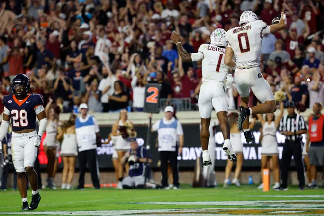 Sep 26, 2025; Charlottesville, Virginia, USA; Florida State Seminoles wide receiver Duce Robinson (0) celebrates with Seminoles quarterback Tommy Castellanos (1) after catching a touchdown pass against the Virginia Cavaliers at Scott Stadium. Mandatory Credit: Geoff Burke-Imagn Images
